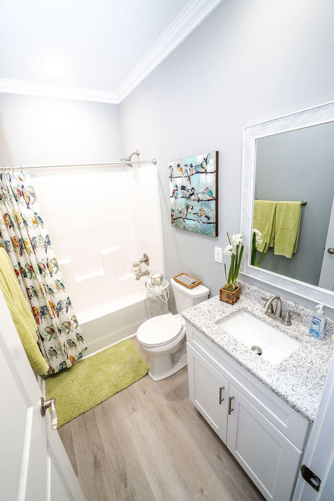 A bathroom with a sink , toilet , bathtub and mirror.