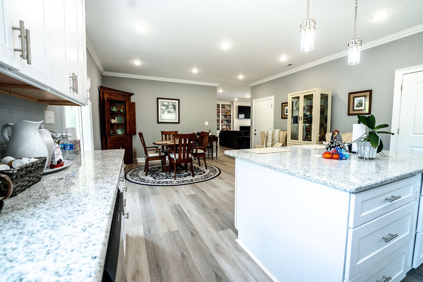 A kitchen with granite counter tops and a large island in the middle of the room.