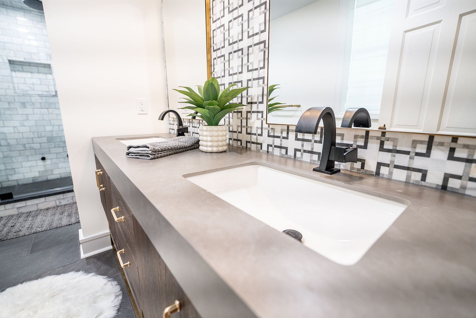 A bathroom with two sinks and a large mirror.