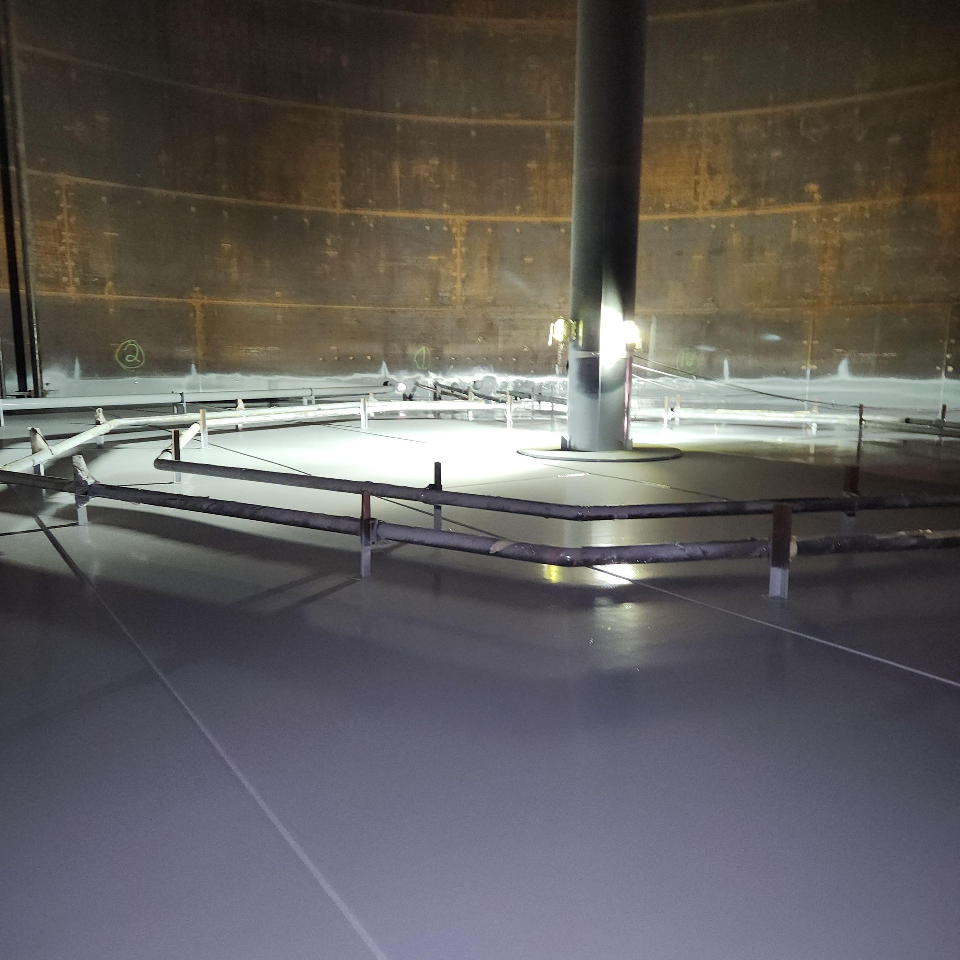 Clean, glossy finish after interior tank painting and coating application inside a petroleum or chemical storage tank