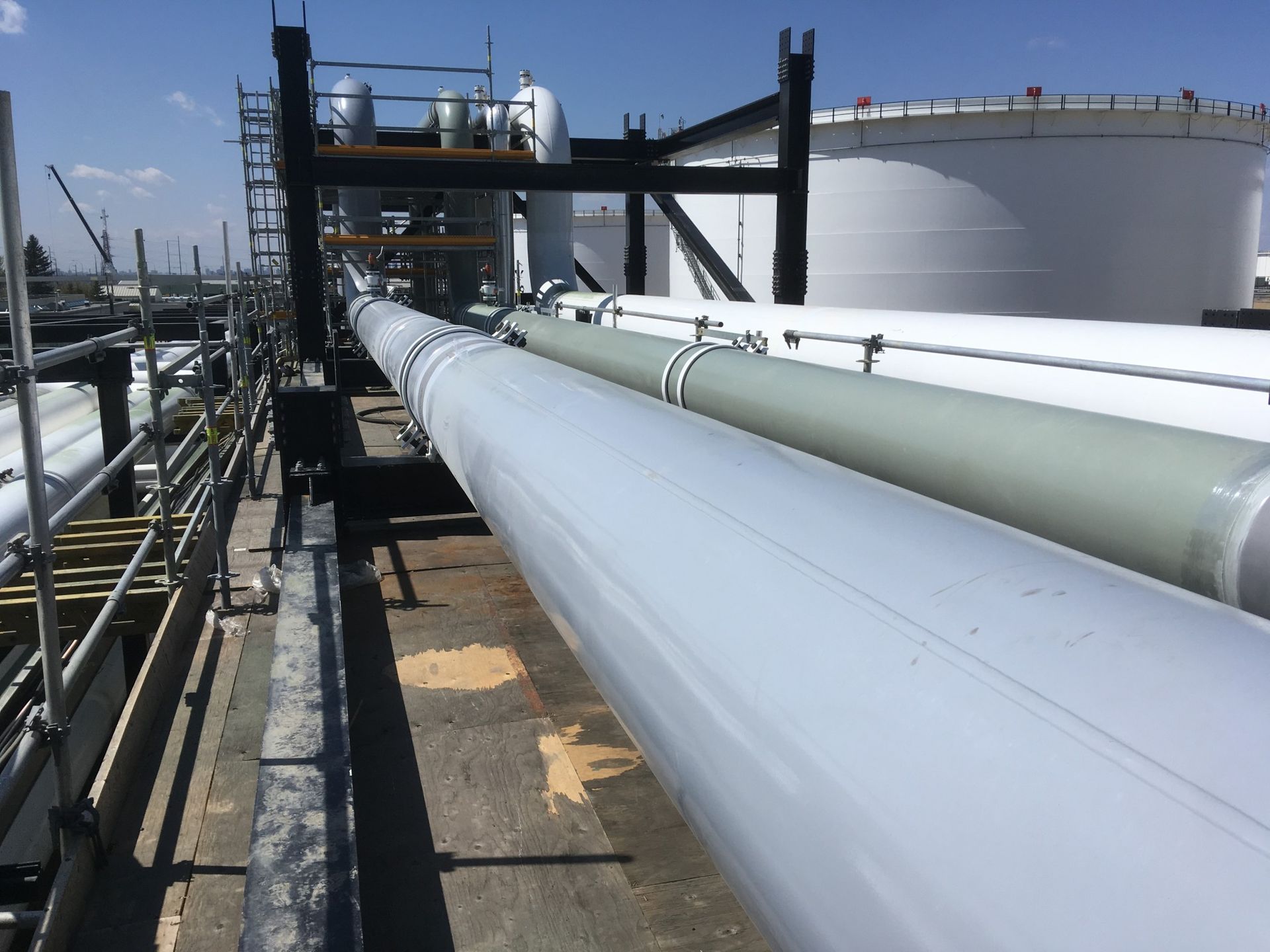 Long pipeline coated for corrosion resistance at a tank farm facility