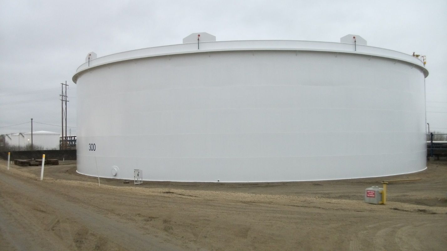 Fully completed tank painting project showing a pristine white finish on a large horizontal storage tank