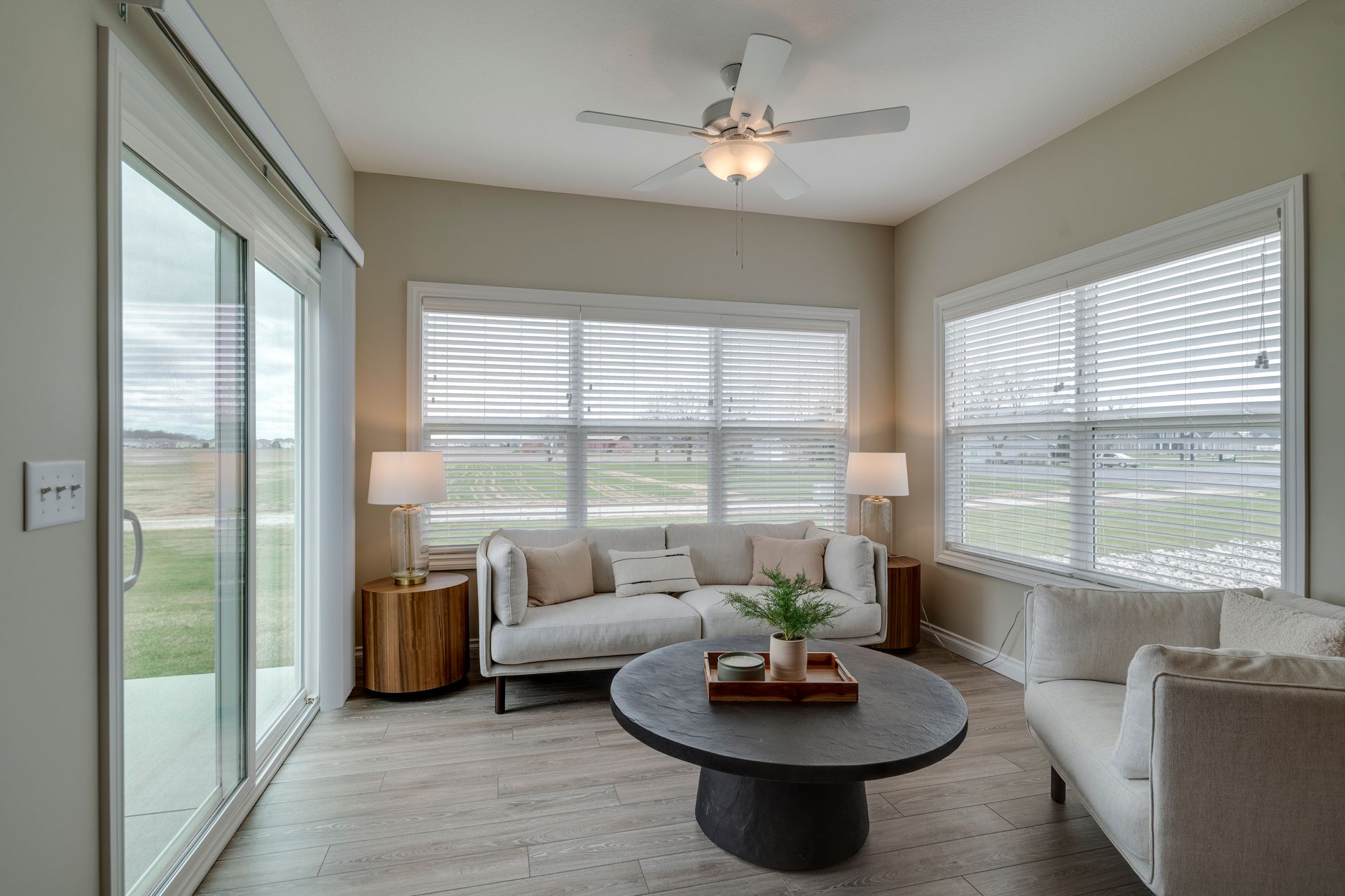 Photo of a unique lounge surrounding by 3 walls, all with windows, allowing for plenty of natural light