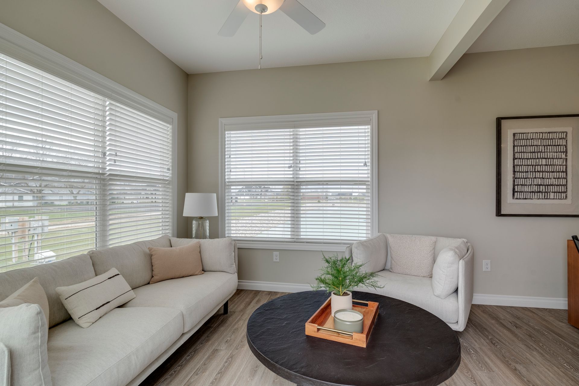 Photo of a room with plenty of natural lighting because two joining walls both have wide windows