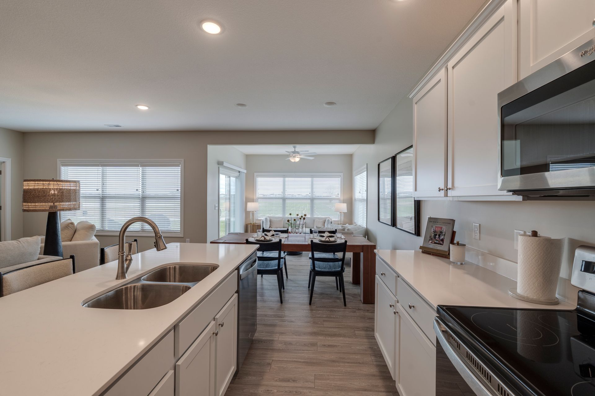 Photo of the kitchen showing the dining table in the middle ground and a lounge area in the background