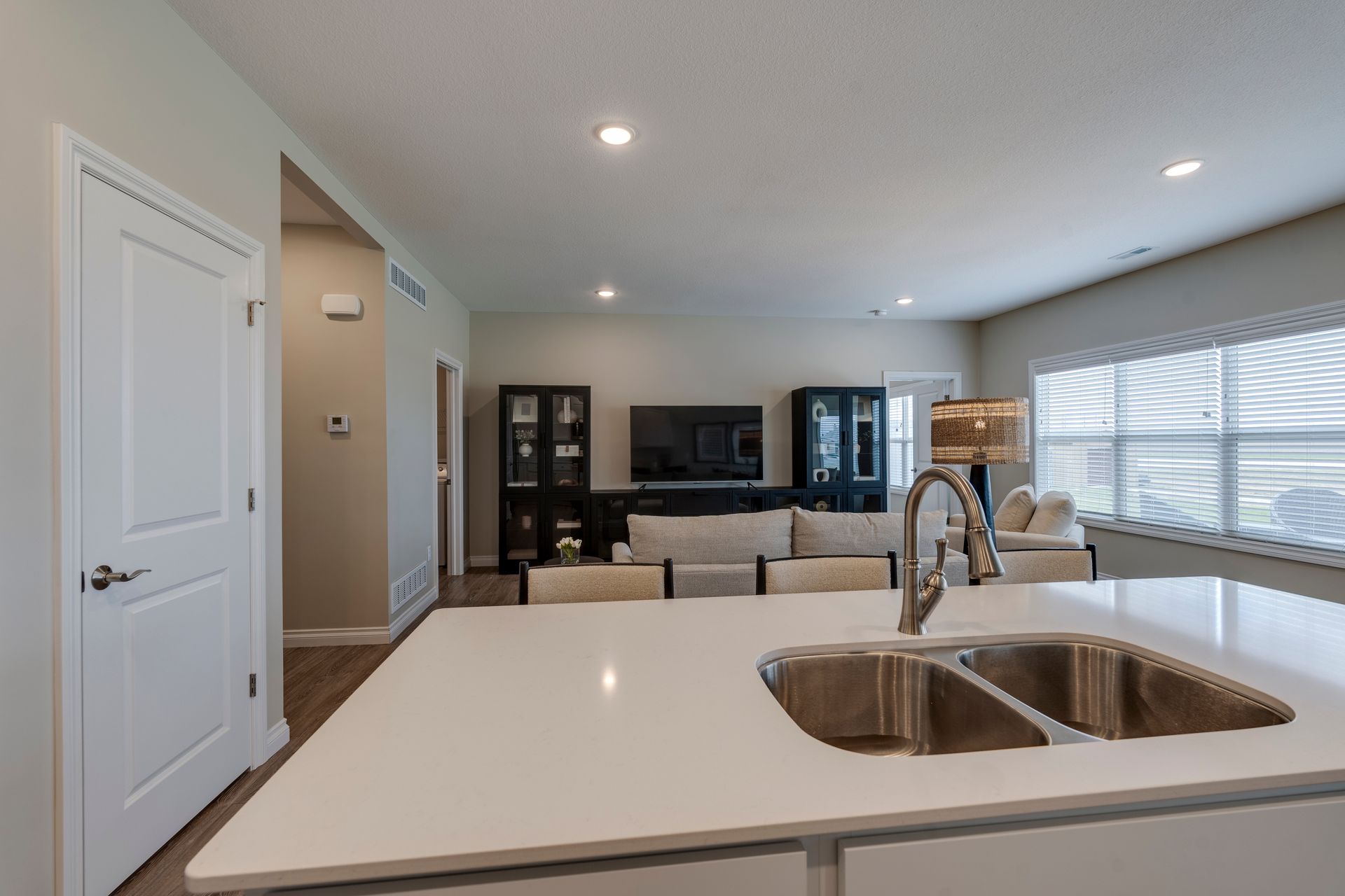 Photo of a kitchen island showing the living room in the background