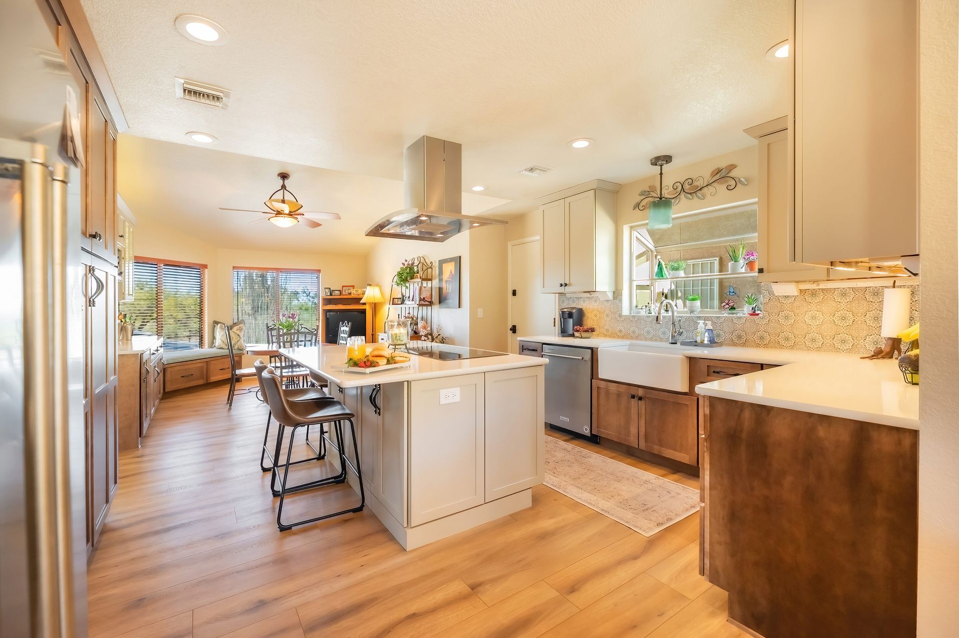 Spacious kitchen with island, stainless steel appliances, and wooden cabinets.