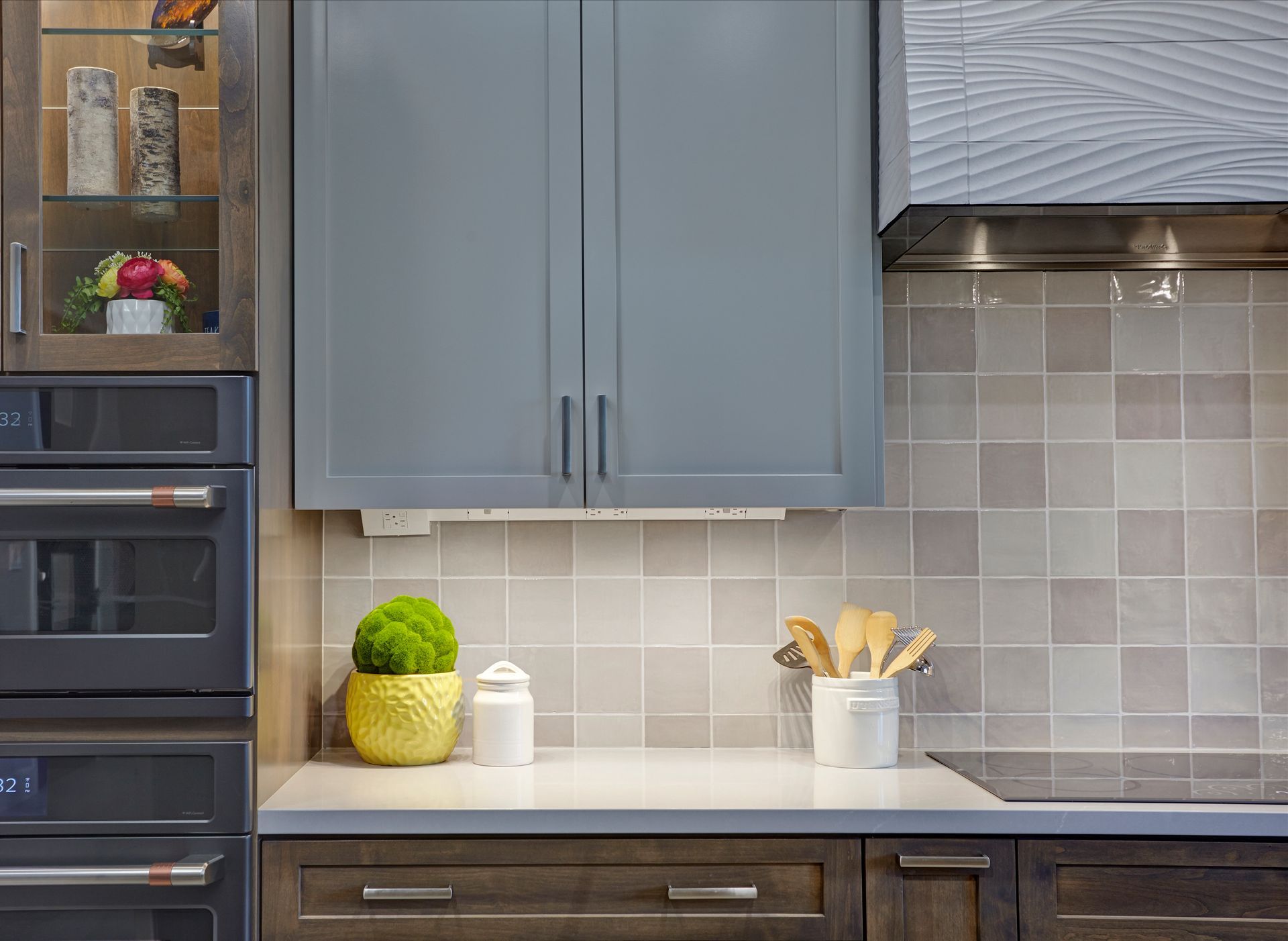 Kitchen with gray cabinets, wooden lower cabinets, and a white countertop.
