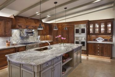 Kitchen with wooden cabinets, granite countertops, and a large island.