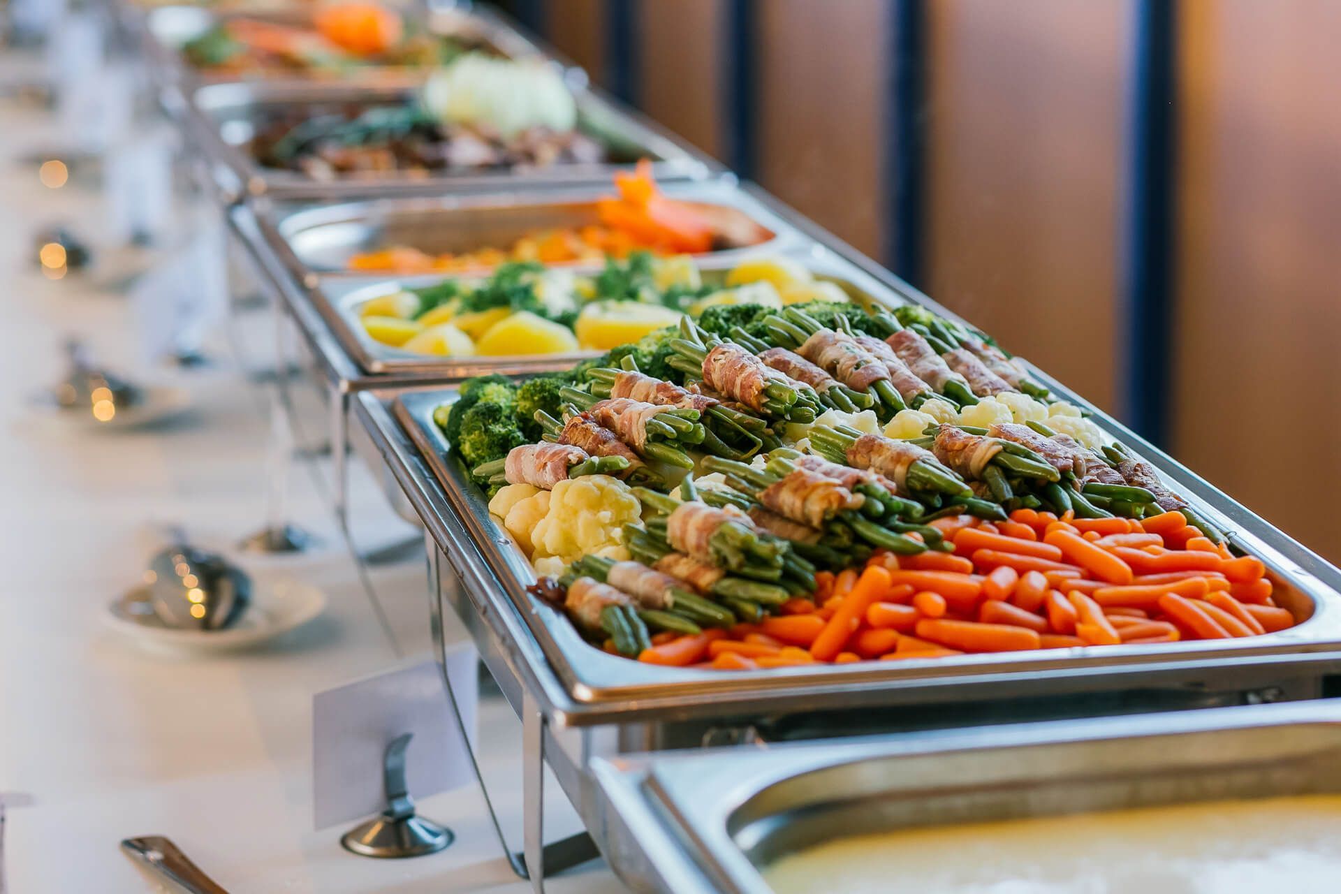 A long buffet line filled with lots of different types of food