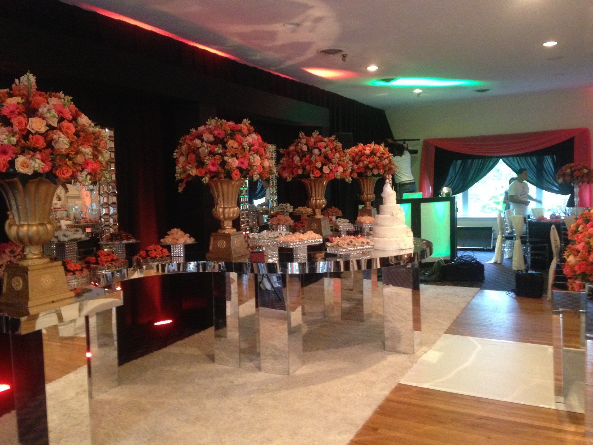 A room with tables and vases of flowers on them