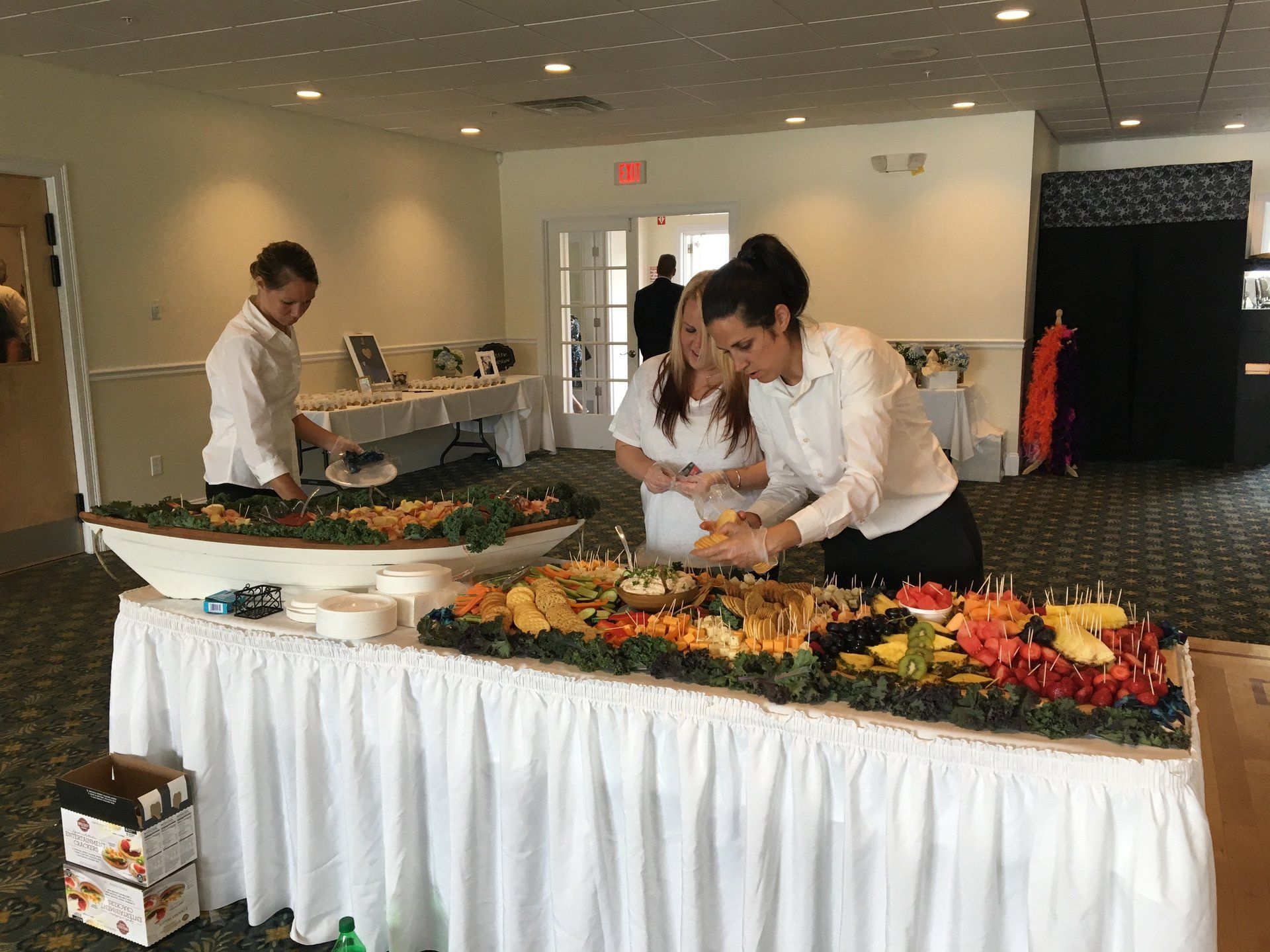 A group of people are standing around a buffet table