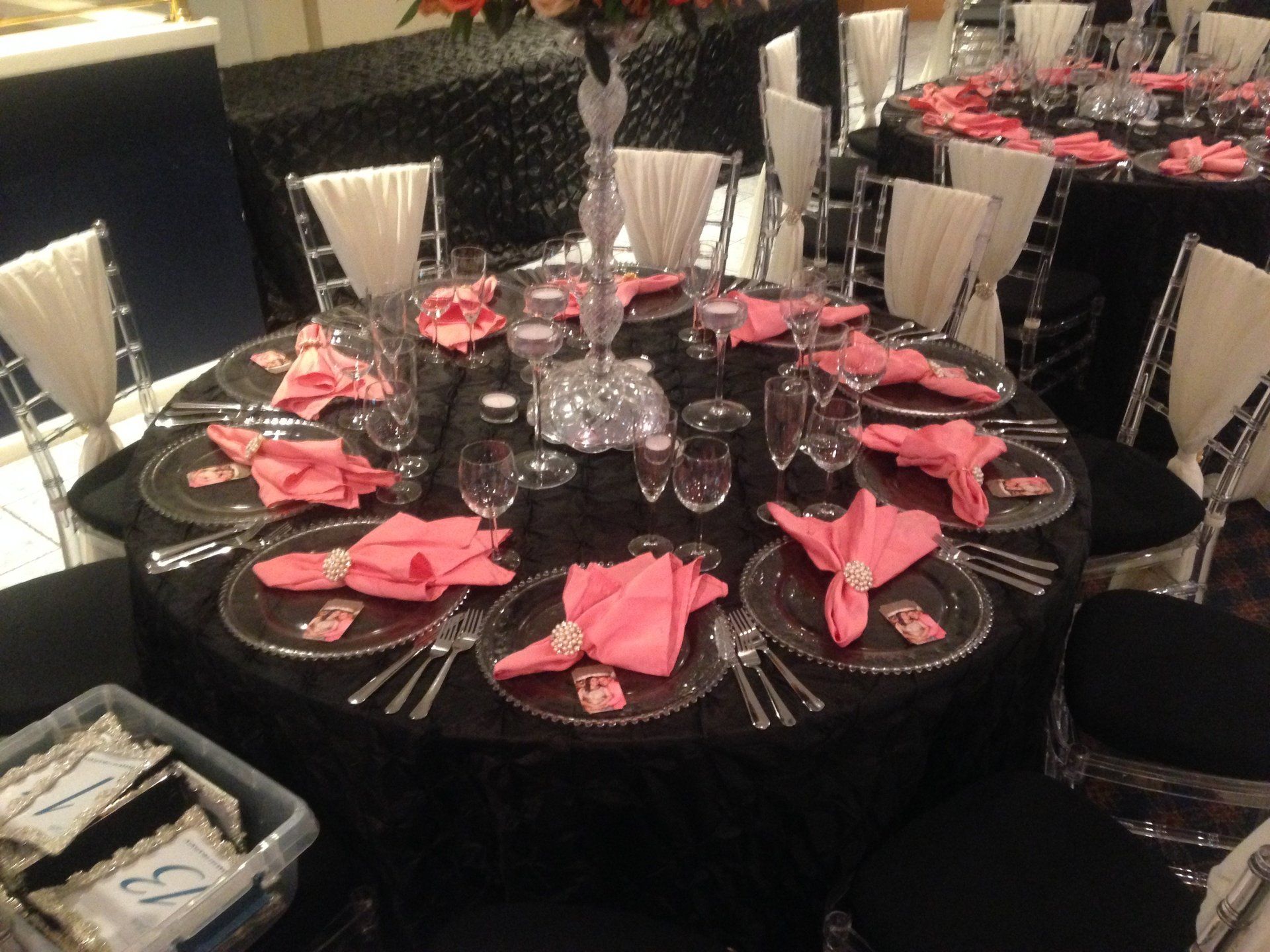 A table set for a party with pink napkins and plates