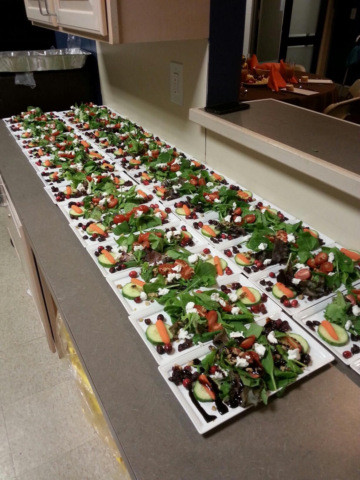 A long row of salad plates on a counter