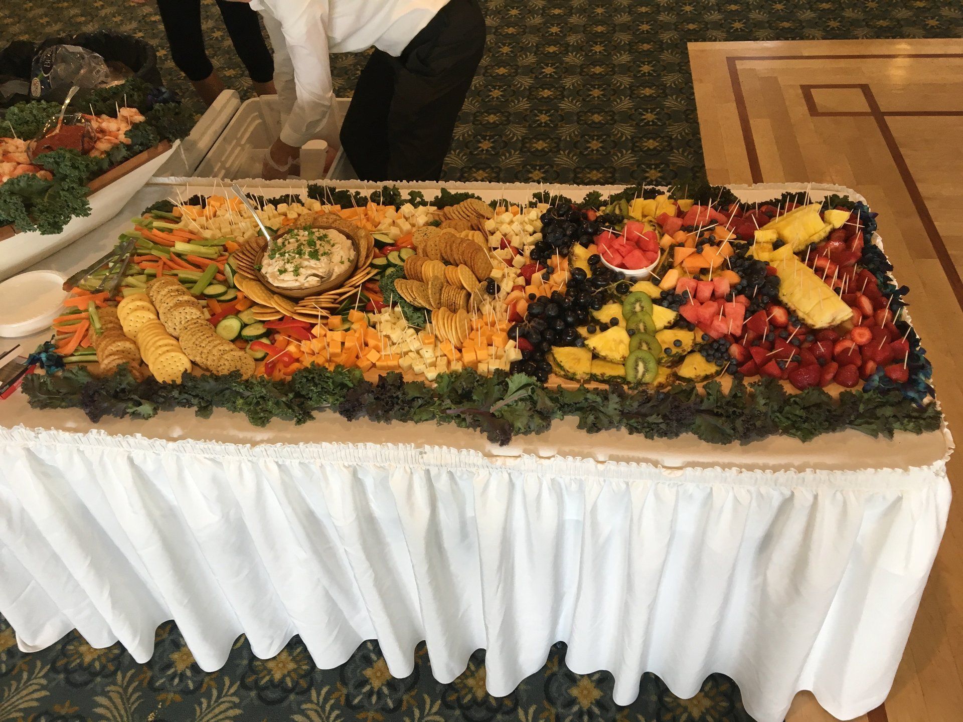 A buffet table with a variety of fruits and vegetables on it