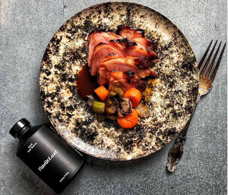 A plate of food next to a bottle that says roasted lamb