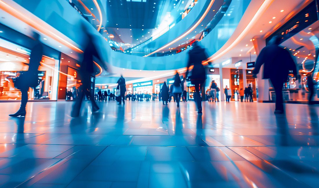 High traffic commercial area with several people walking in multiple different directions.