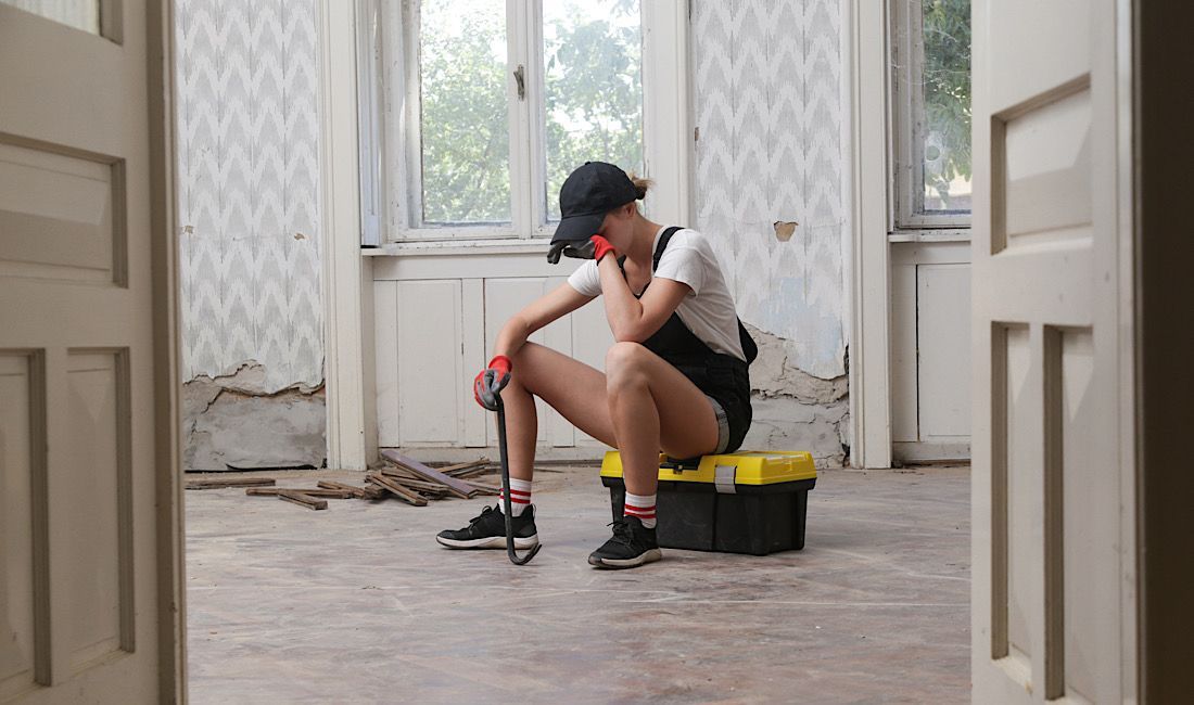Young woman frustrated with DIY home improvement project.