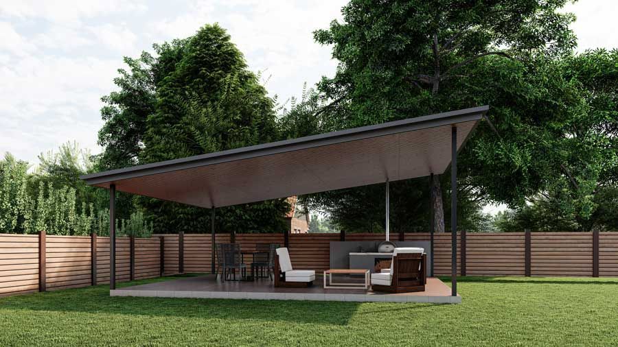 Modern backyard patio with a slanted roof, outdoor seating, and a wooden fence surrounded by trees