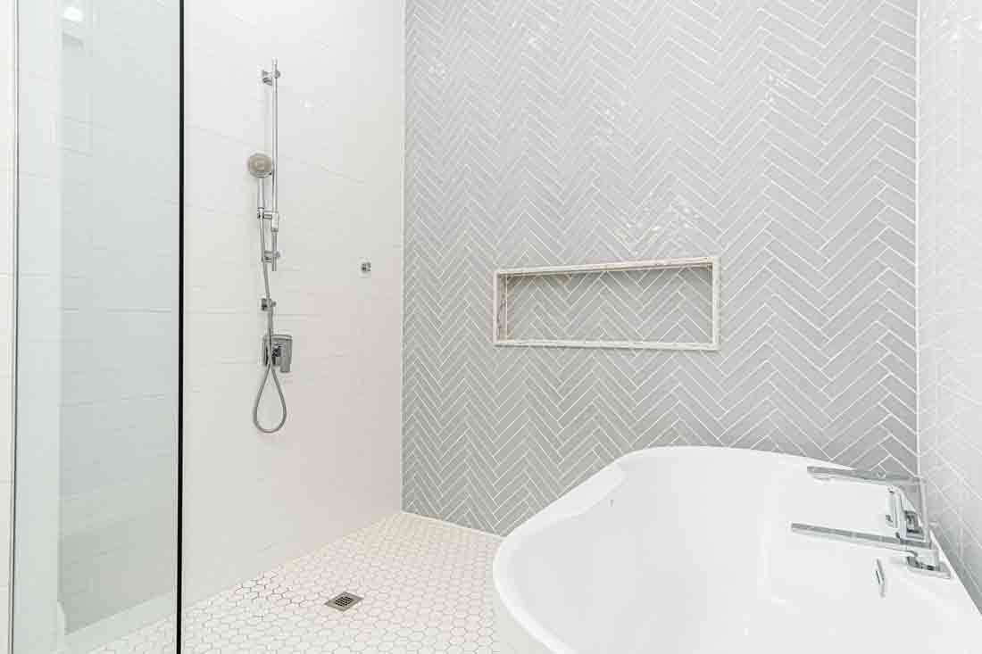 Modern white bathroom with a walk-in shower and freestanding bathtub