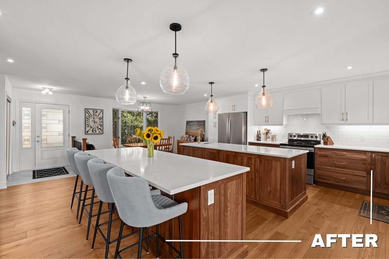 Bright modern kitchen with white island, gray barstools, wood cabinets, and pendant lights