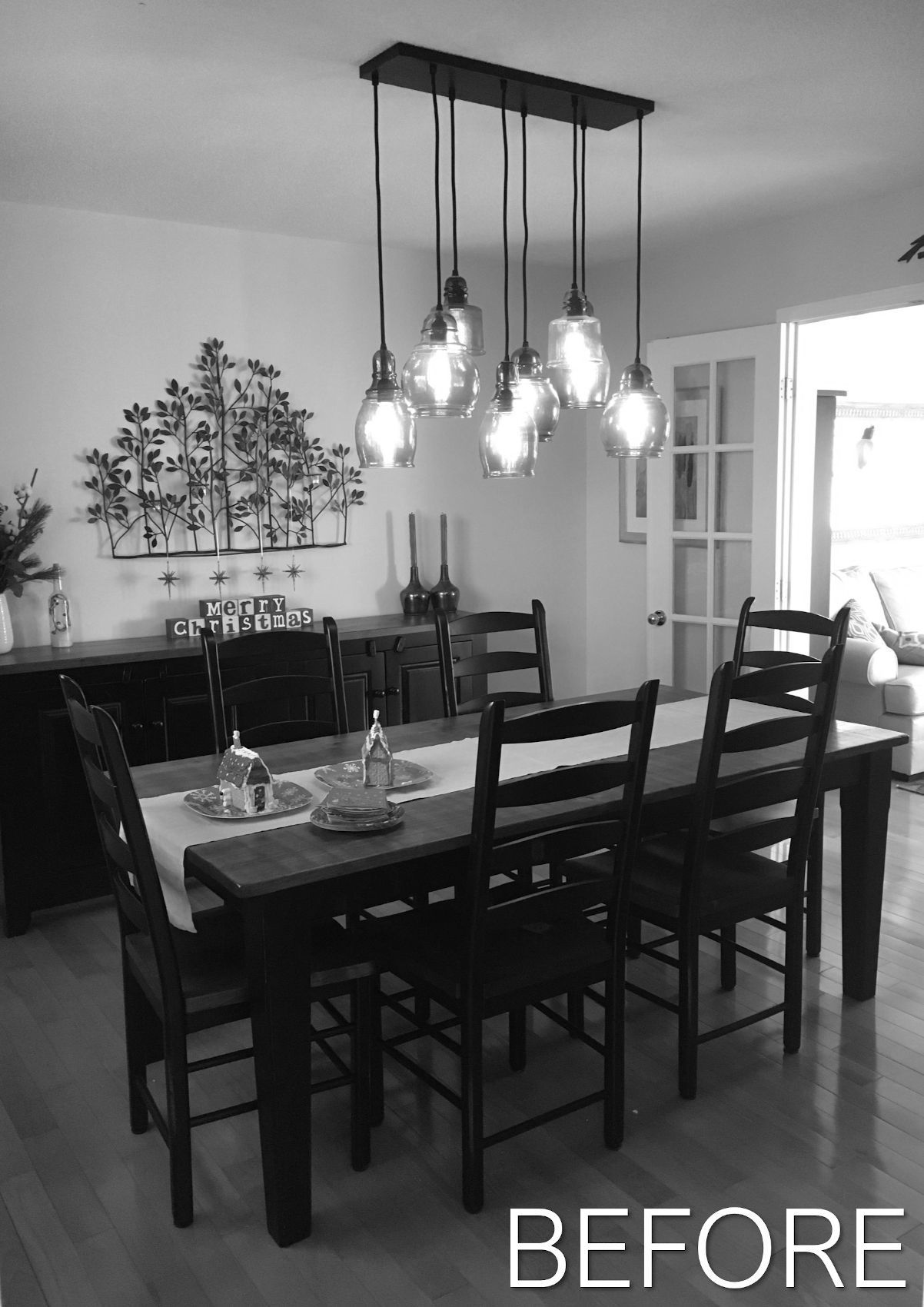 Dining room with dark table and chairs, hanging lights, and wall art; labeled “BEFORE”