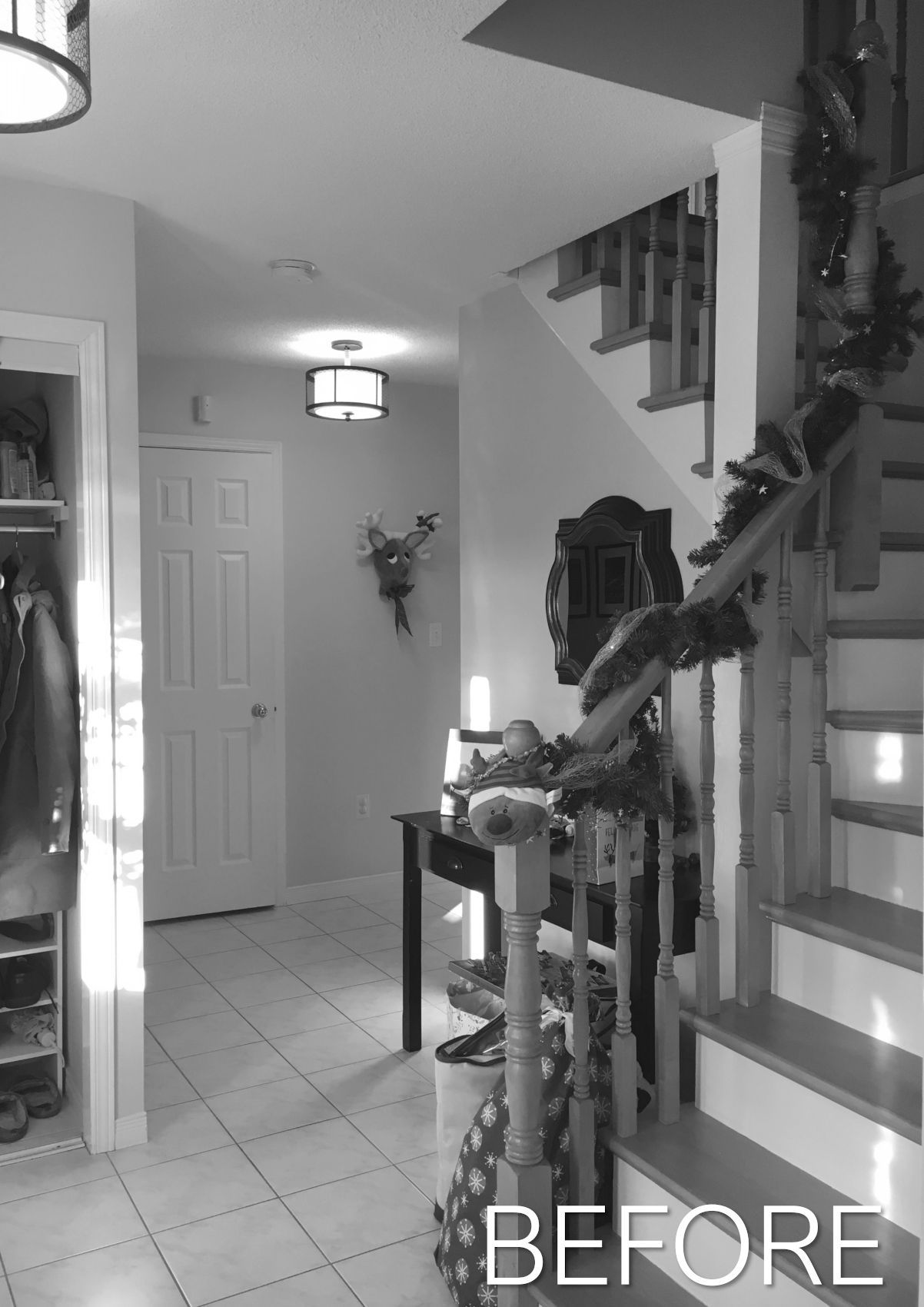 Narrow tiled hallway with staircase, ceiling lights, and a door; “BEFORE” text in the lower right.
