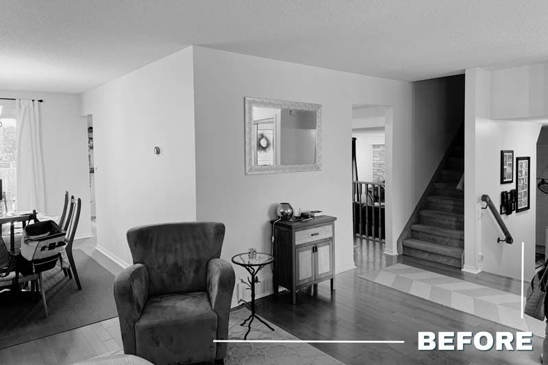 Grayscale living room and hallway with chair, table, dining area, and staircase; “BEFORE” text in corner