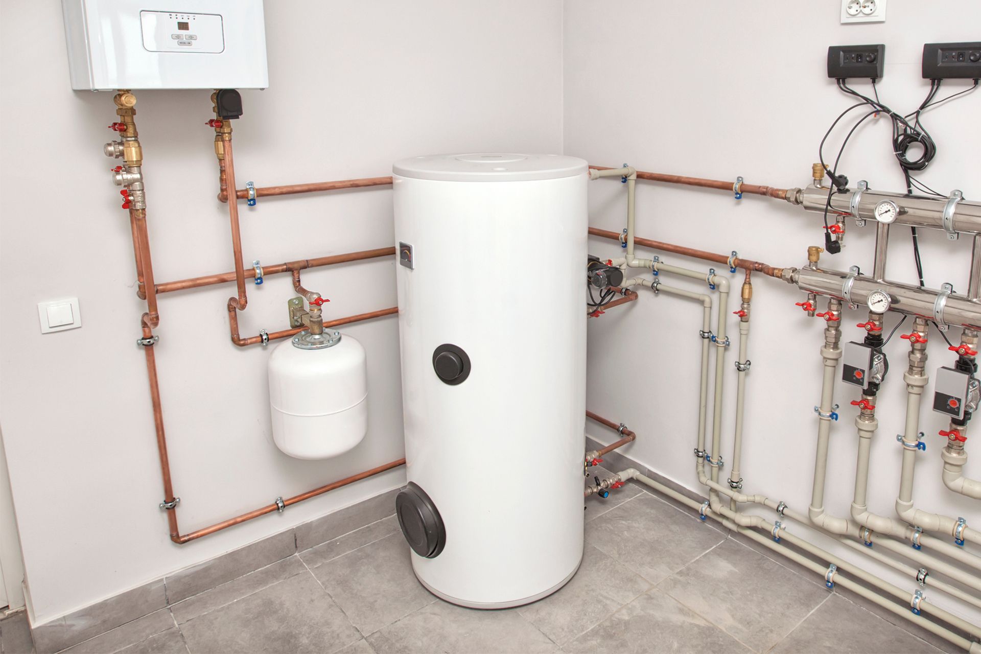 White water heater and related plumbing in a utility room in Teaneck, NJ