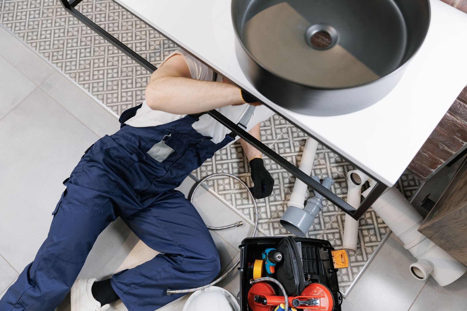 Woman and worker shaking hands in a kitchen, toolbox on the floor in Teaneck, NJ