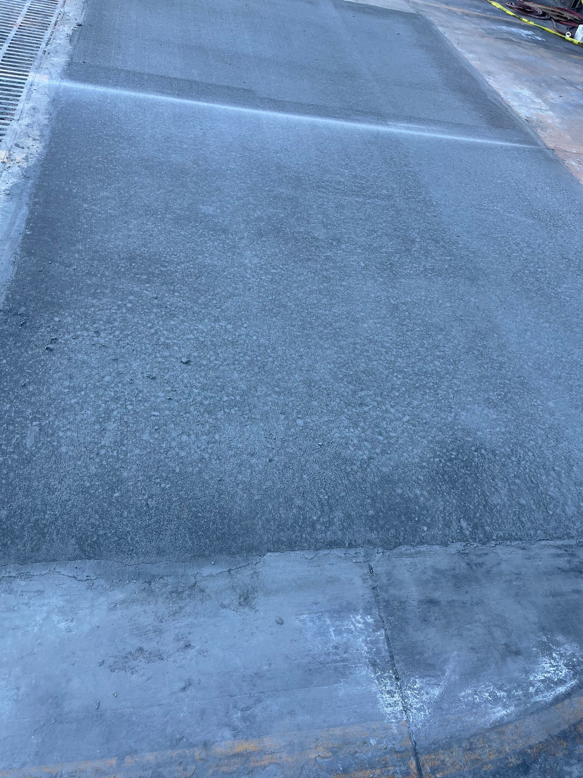 Icy road with a white painted line and frosty pavement edges
