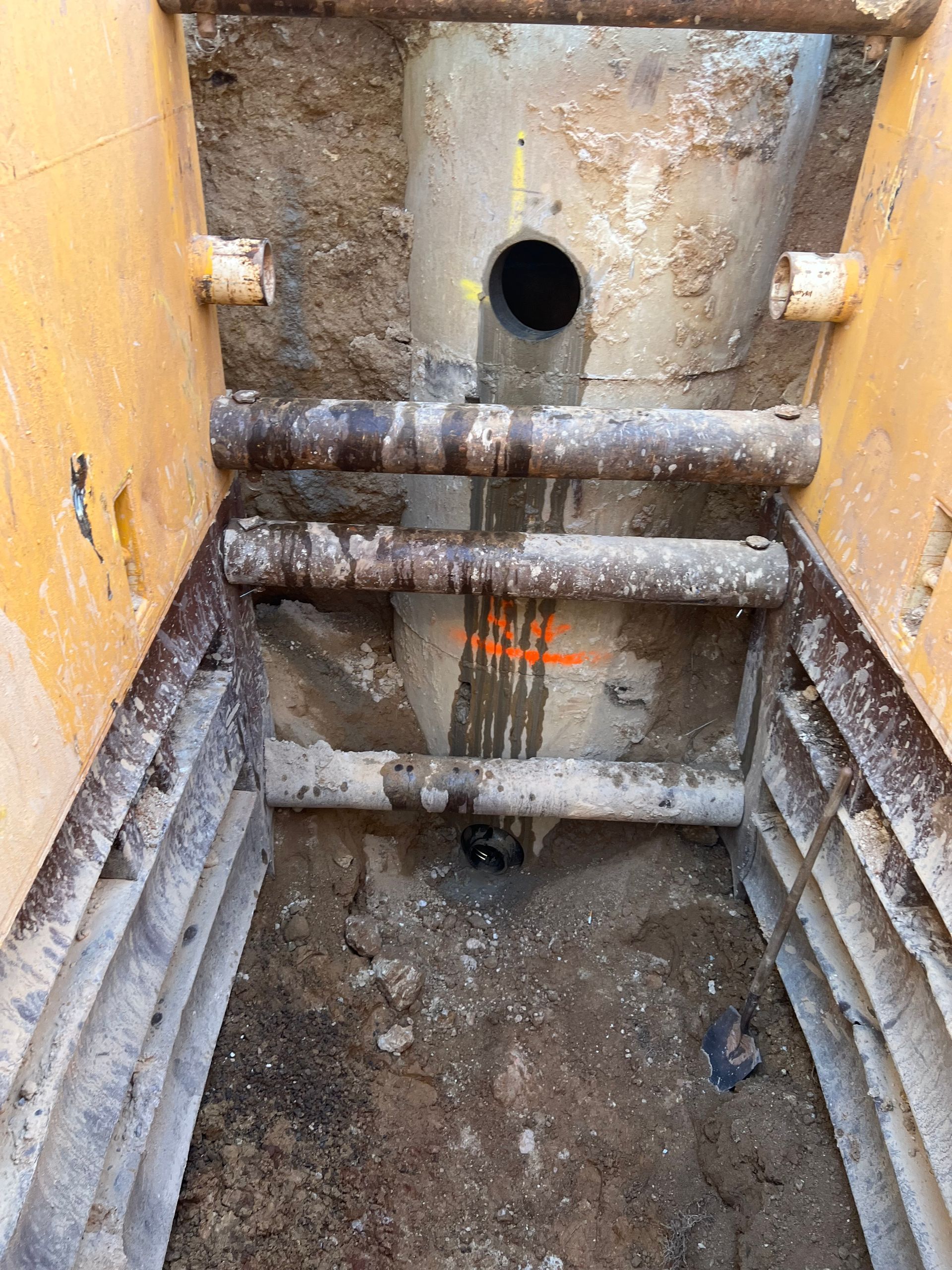 A person is using a machine to drill a hole in the ground.