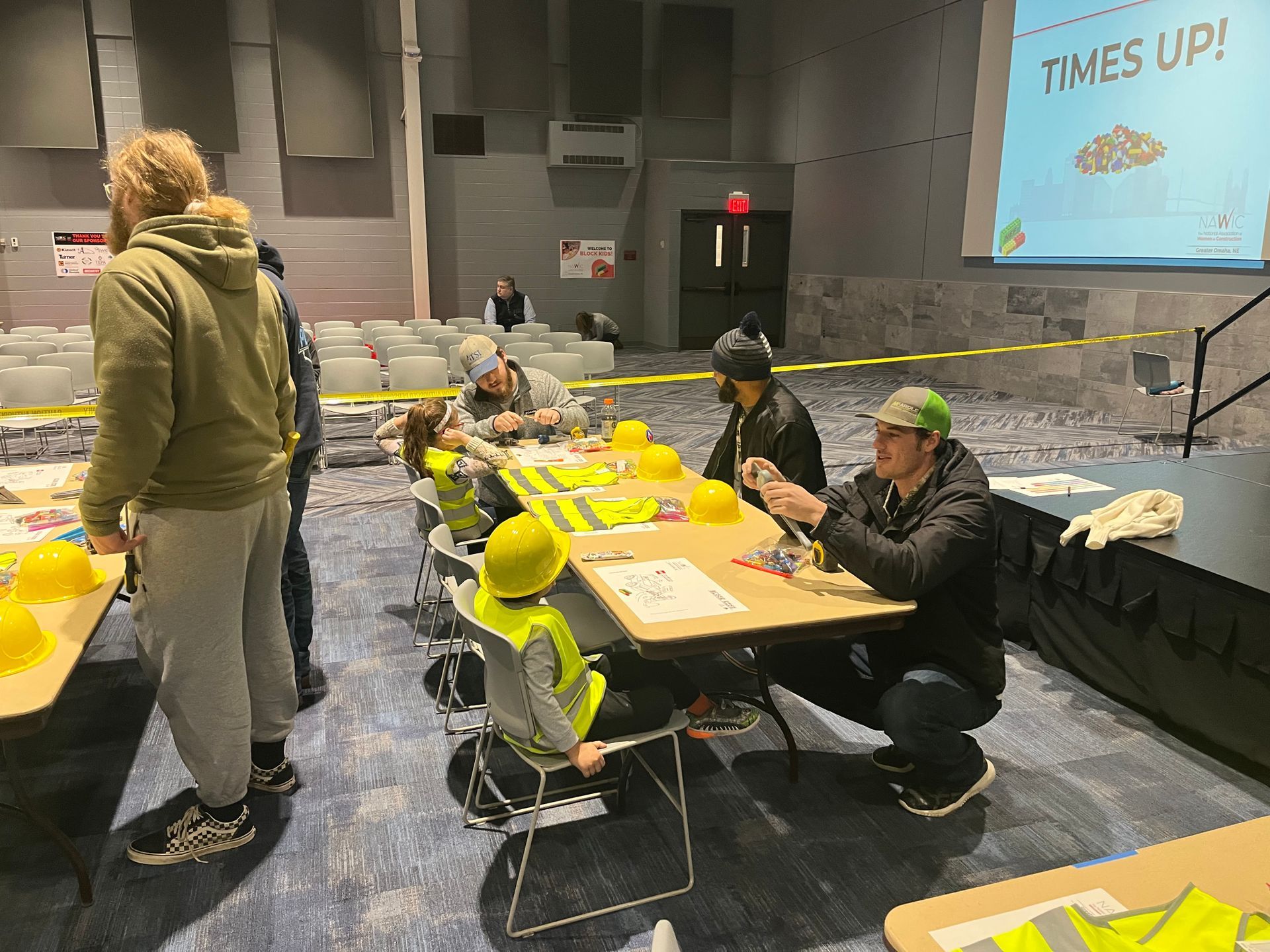 A group of people are sitting around a table in a room.
