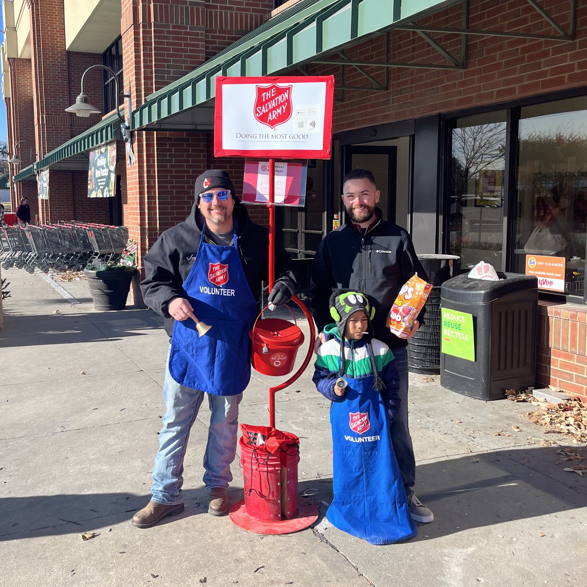 Local 16 members stand next to a Salvation Army donation bin