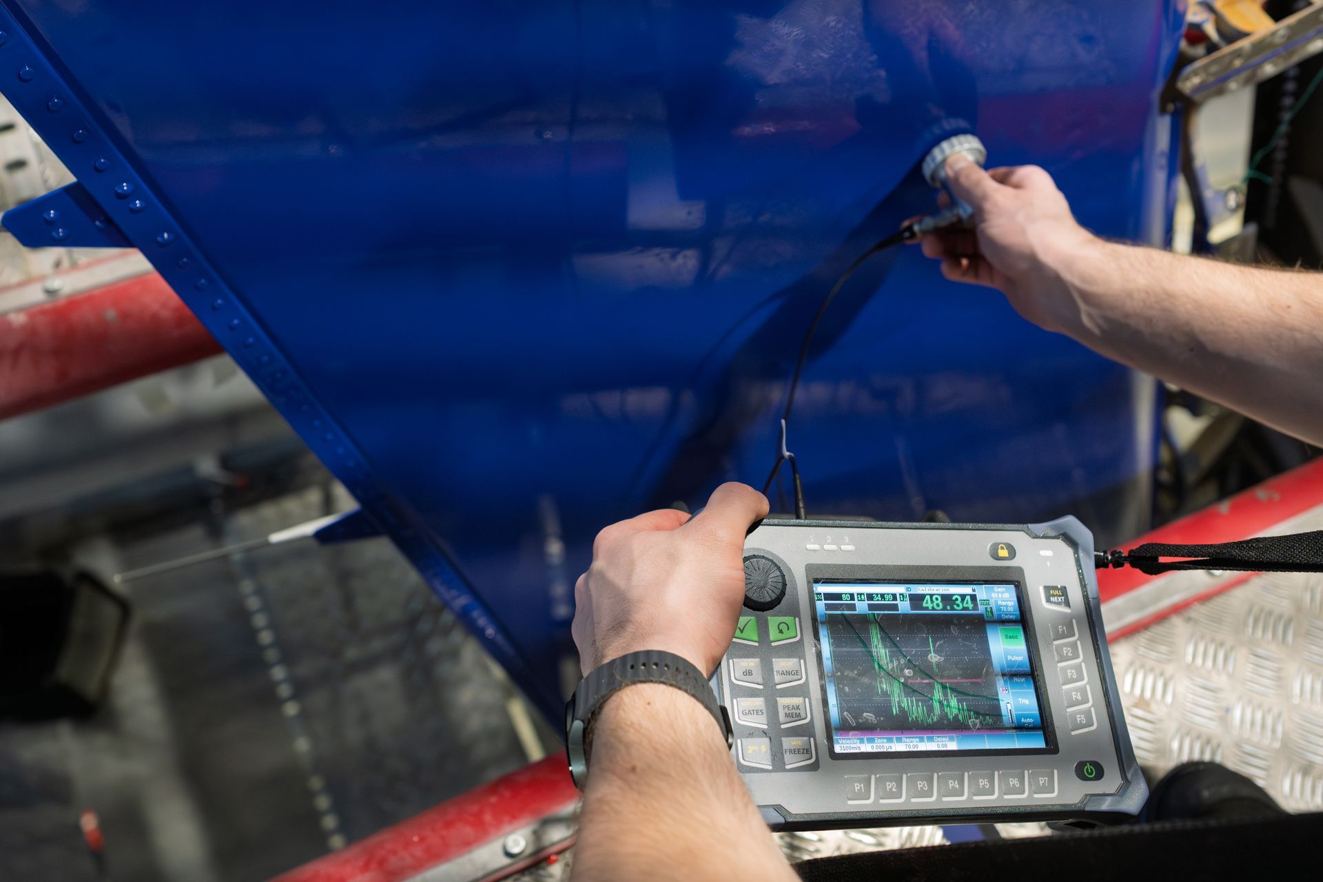 ultrasonic testing NDT technician performing ultrasonic testing on a metal component for manufacturing quality control
