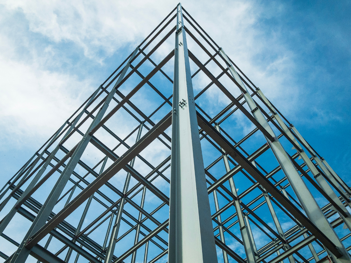 Looking up at a building under construction with a blue sky in the background
