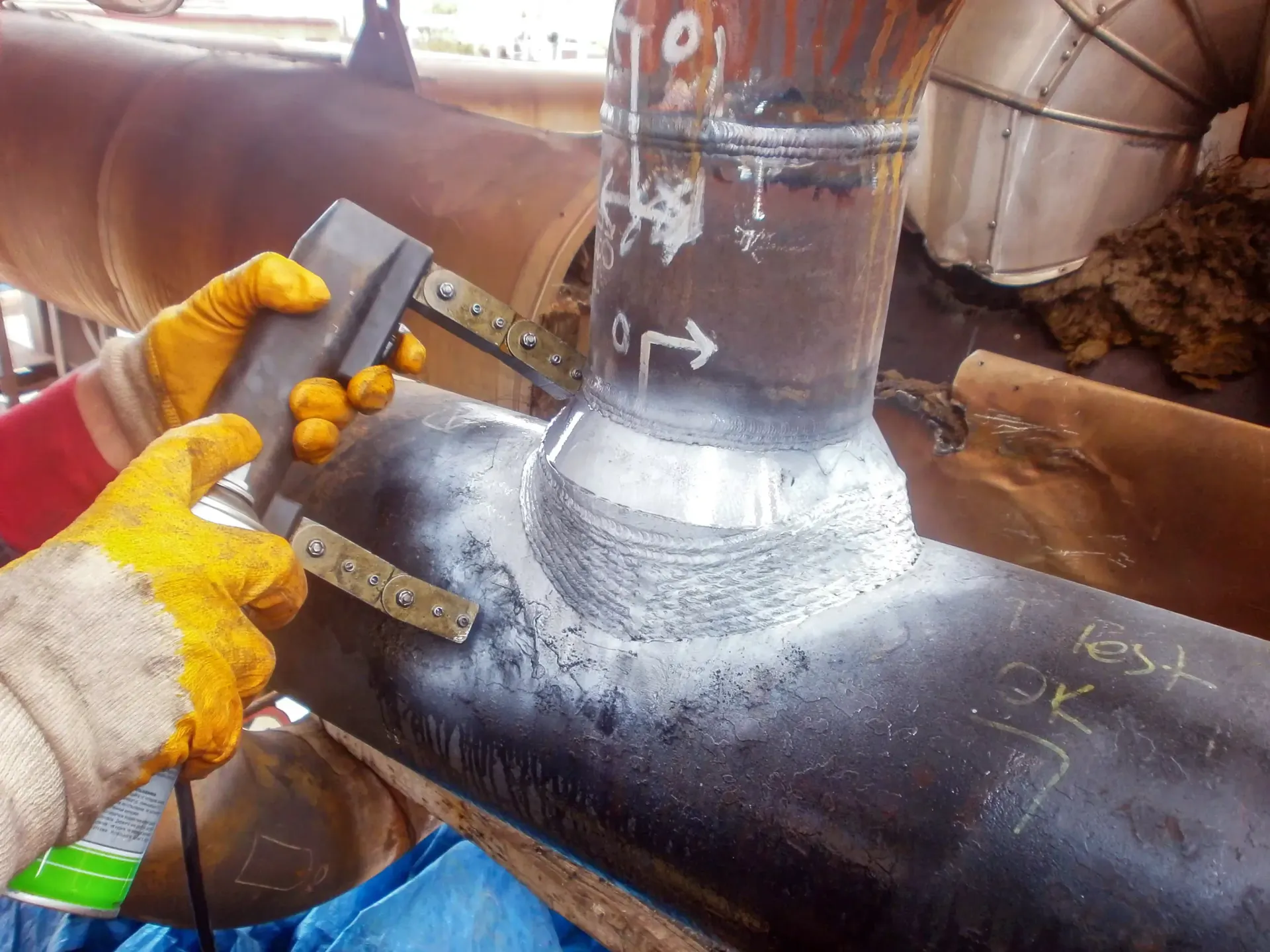 A person is using a magnetic detector on a pipe. A person is using a magnetic detector on a pipe.