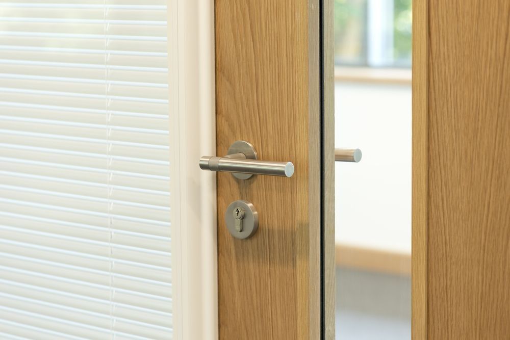 Wooden Door With Silver Handle — Shaine Hunter Locksmiths in Mount Isa City, QLD