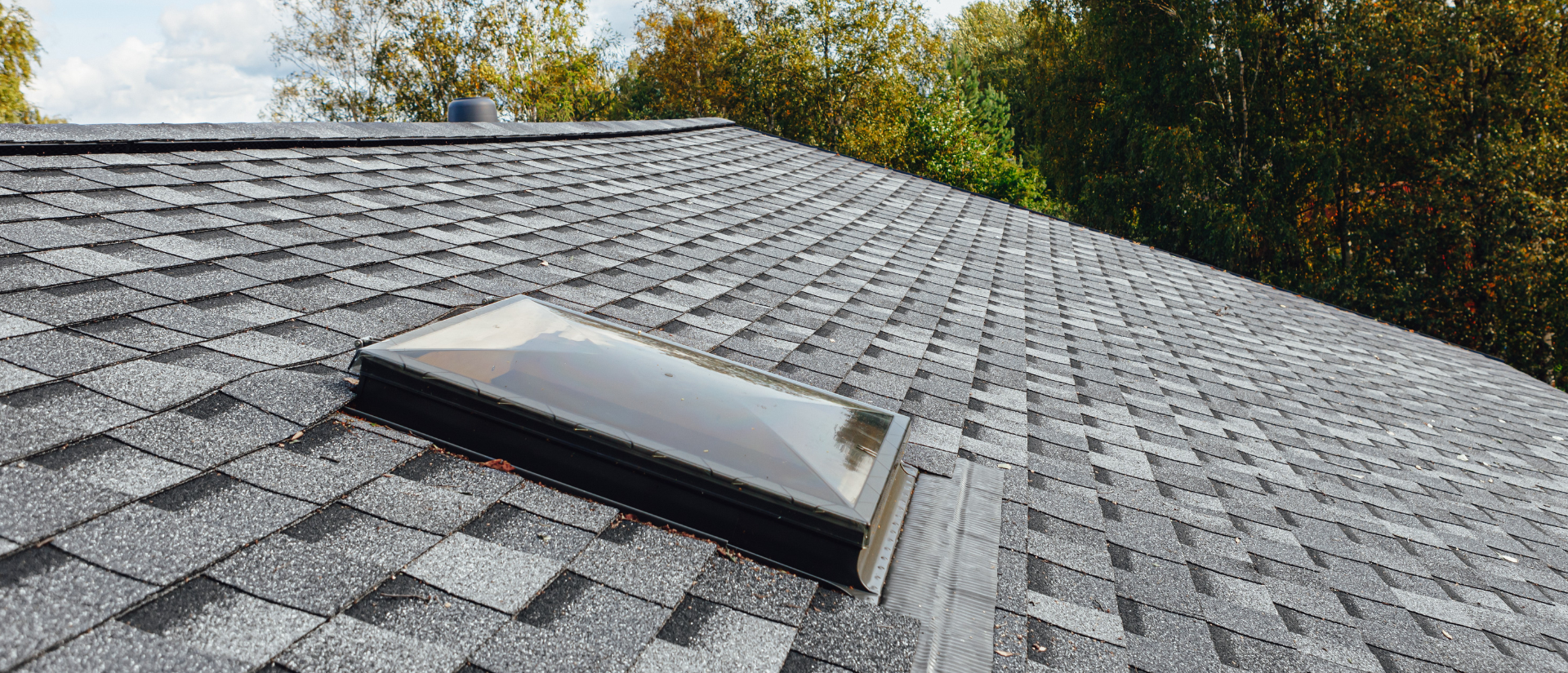 There is a skylight on the roof of a house.