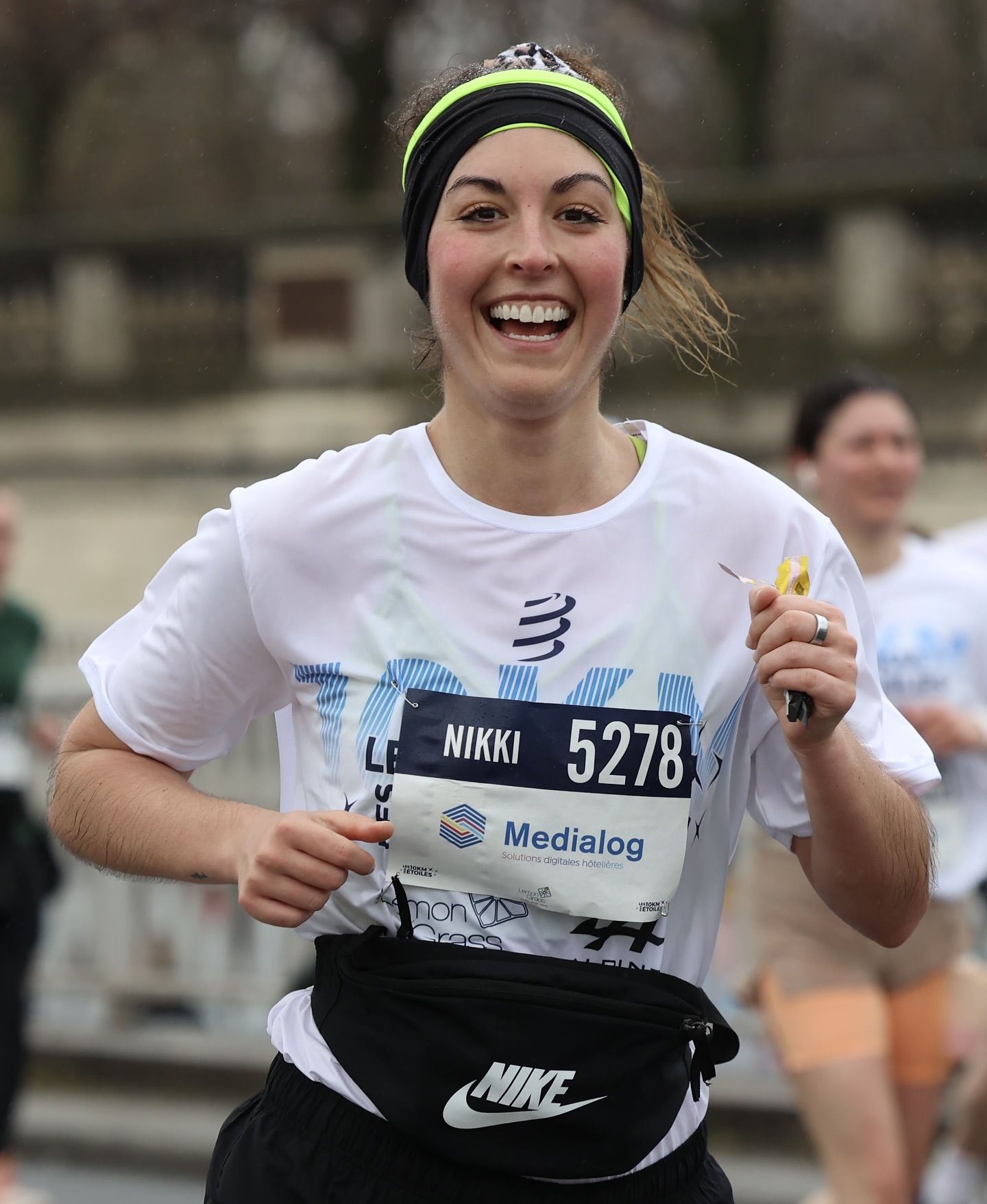 A woman wearing a white shirt with the number 5278 on it