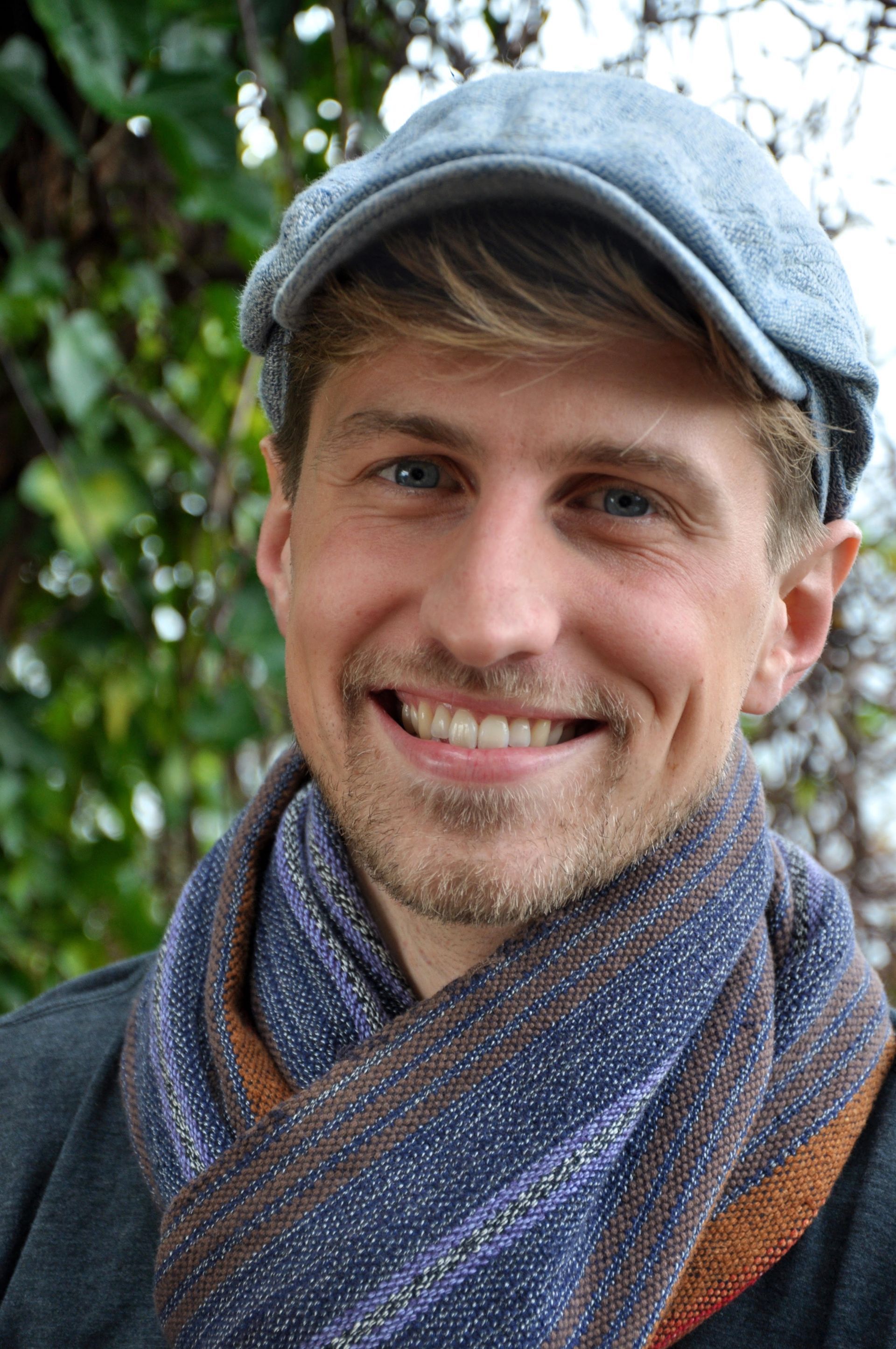 Kelsey Tonner Headshot Outside in Hat Founder of Guest Focus