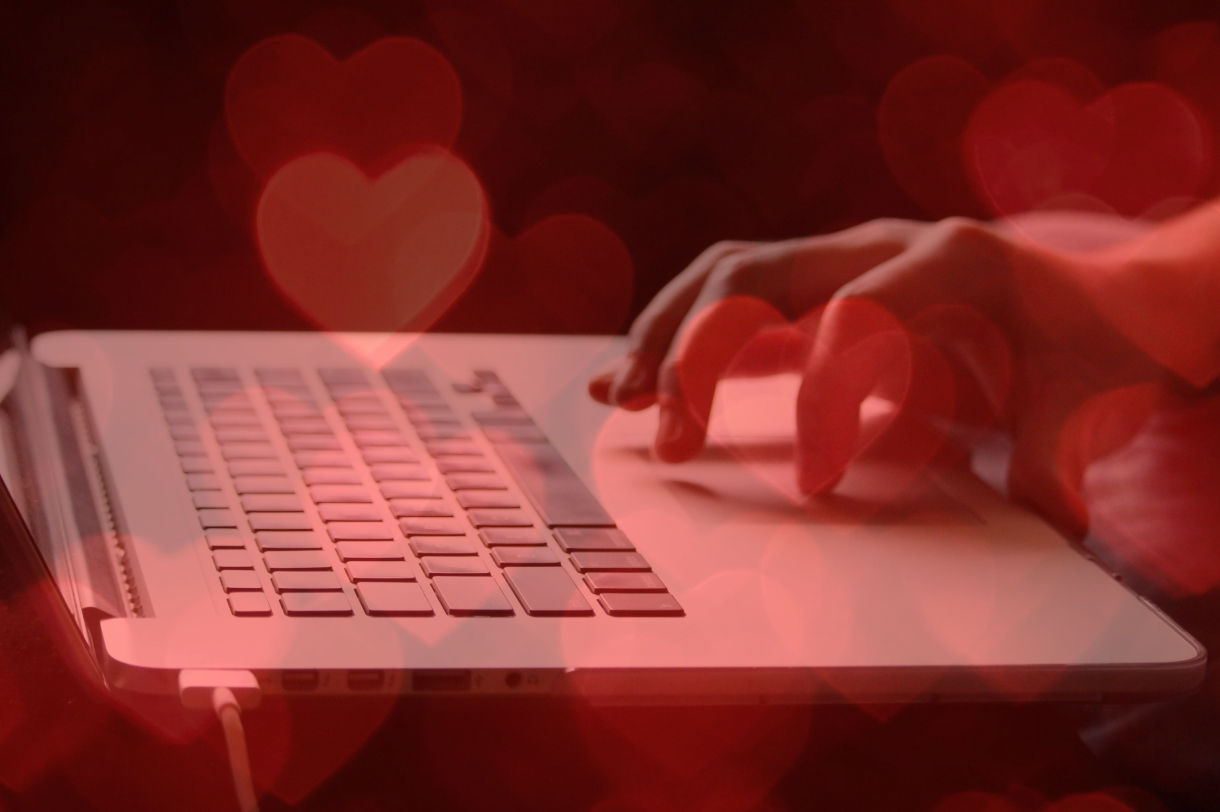 fingers on the trackpad with hearts layover