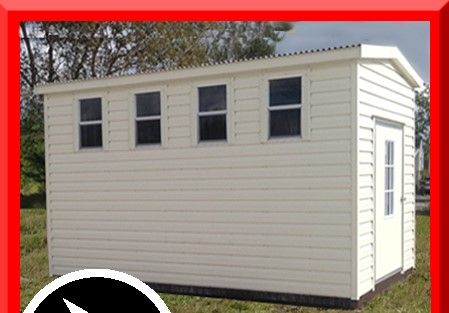 A small white shed with a red frame around it