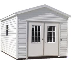 A white shed with two doors and two windows.