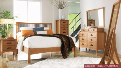 Bright bedroom with wooden bed, dresser, mirror, nightstand, and white bedding