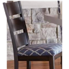 Dark wood dining chair with blue patterned cushion in front of a stone wall