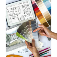 Hands holding paint swatches over architectural floor plans and design sketches