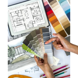 Hands holding paint swatches over architectural floor plans and design sketches