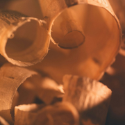 Close-up of curled brown paper spirals lit by warm orange light
