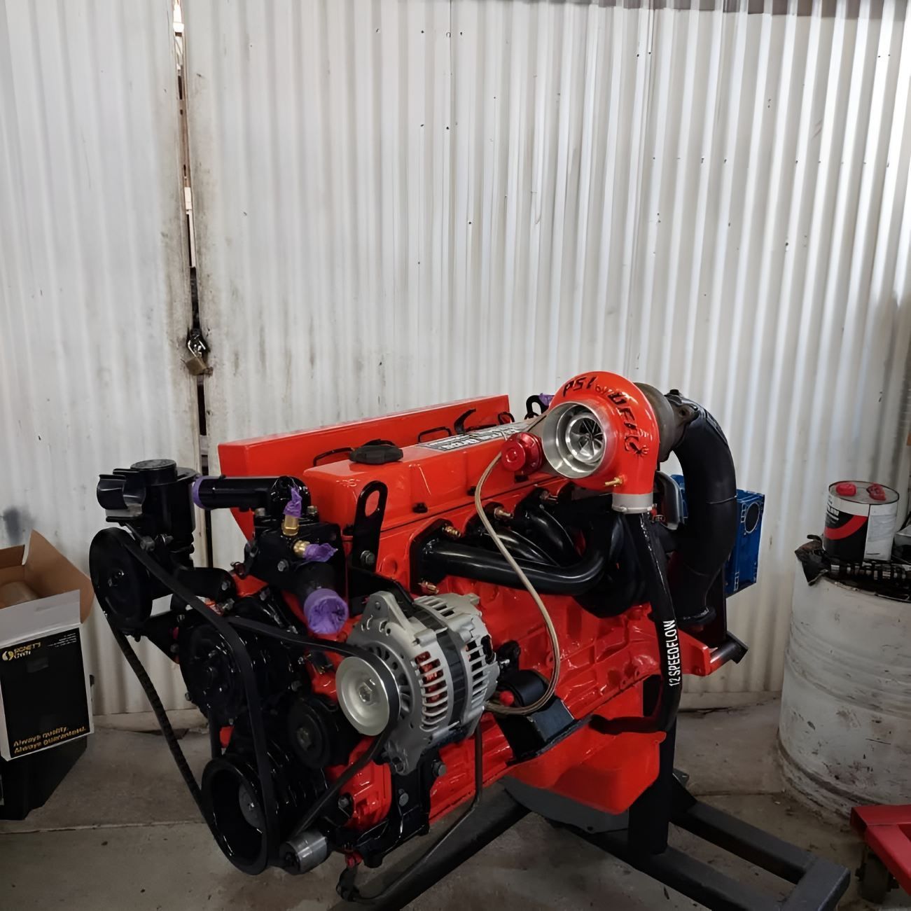 A Red Engine With a Turbo is Sitting on a Stand — Currie Bros Engine Reconditioners in Coffs Harbour, NSW